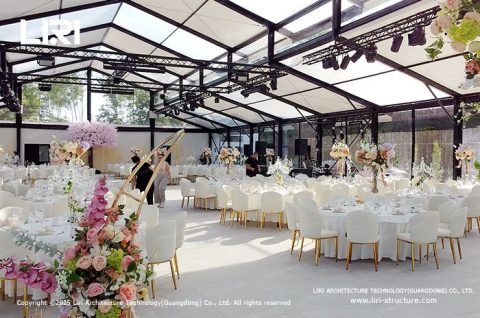 Elegant Atrium Tent Structure with transparent glass walls and PVC roof resembling a grand glass chapel