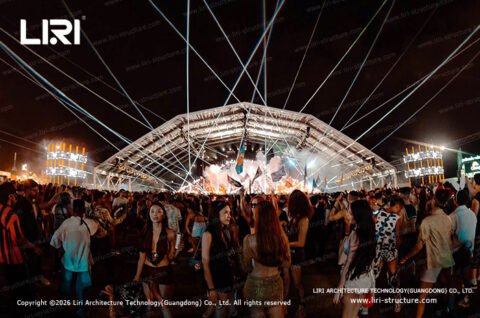 Festival light show under a large temporary tent structure