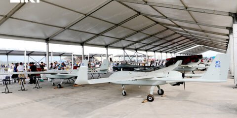 Lightweight aluminum hangar sheltering light aircraft on an airfield