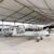 Lightweight aluminum hangar sheltering light aircraft on an airfield