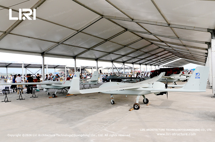 Lightweight aluminum hangar sheltering light aircraft on an airfield