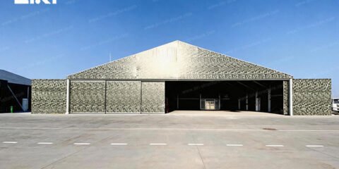 Camouflage modular aircraft hangar with a wide open entrance