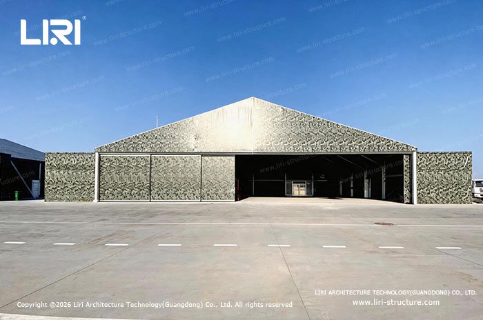 Camouflage modular aircraft hangar with a wide open entrance