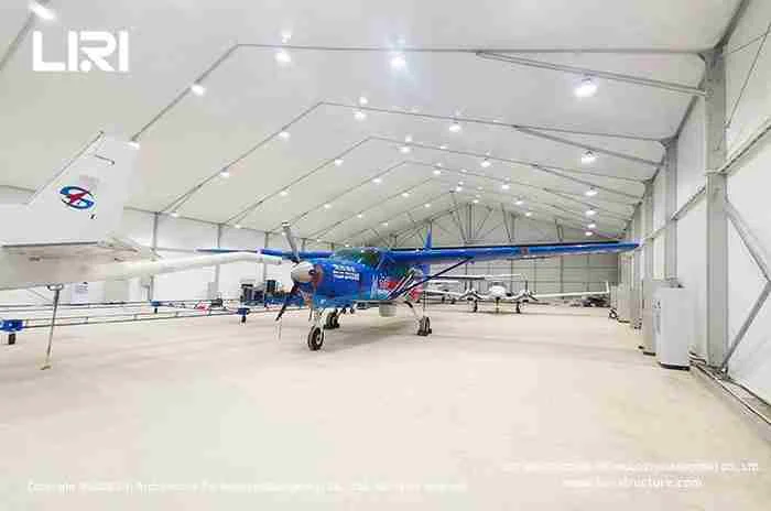 Column-free aircraft hangar interior with light planes parked inside