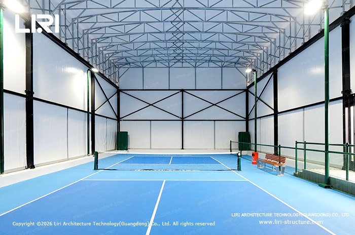 Indoor pickleball court under a lightweight retractable roof frame