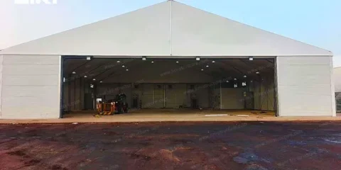 Wide span industrial aircraft hangar tent with open front entrance