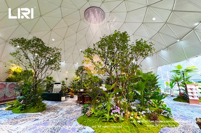 Column-free geodesic dome event interior with landscaped plant displays