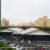 Curved-roof indoor badminton hall exterior in an urban sports complex