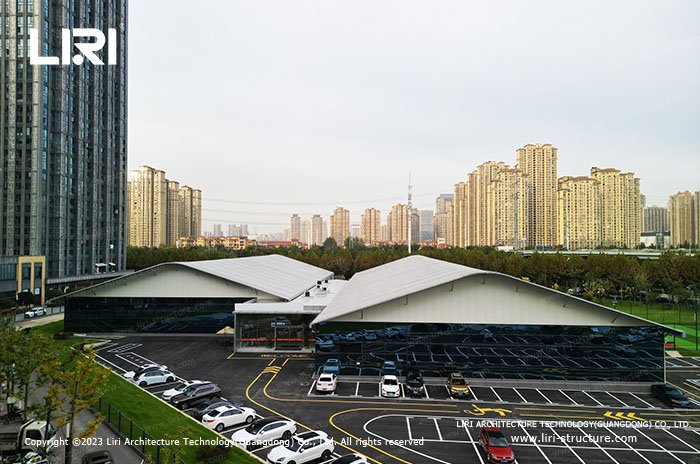 Curved-roof indoor badminton hall exterior in an urban sports complex