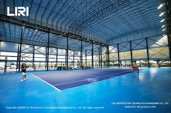 Dual tennis court sports tent with lighting and open side panels
