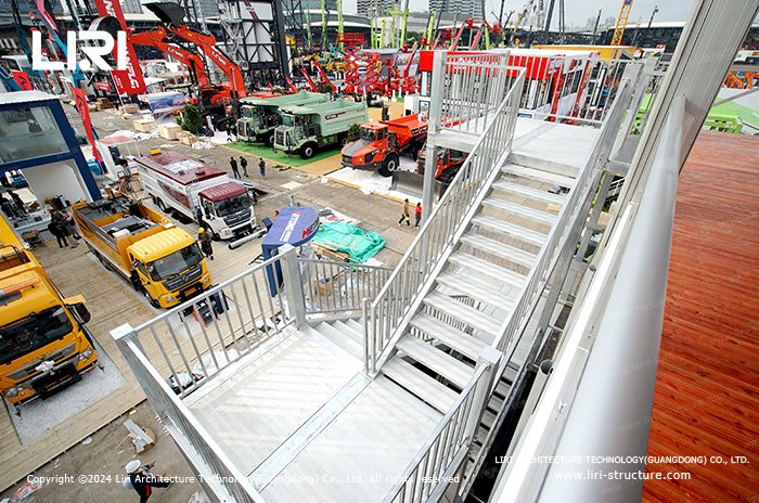 Modular metal staircase connecting the floors of a triple decker event structure