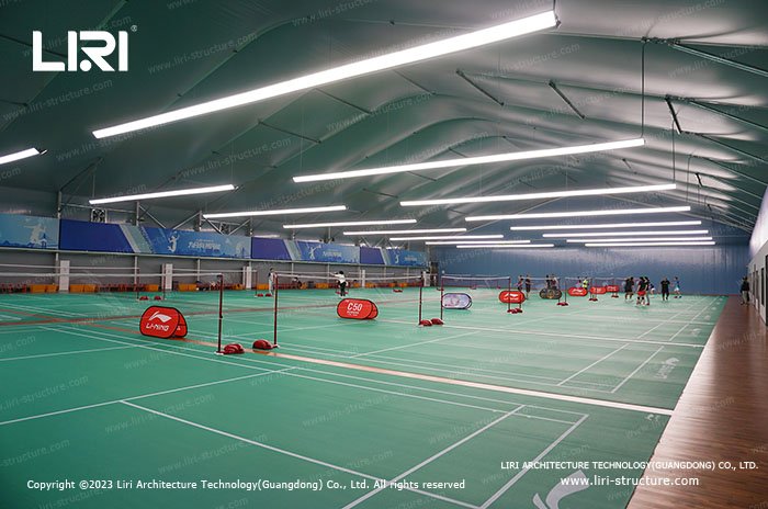 Pillar-free indoor badminton courts with evenly distributed overhead lighting