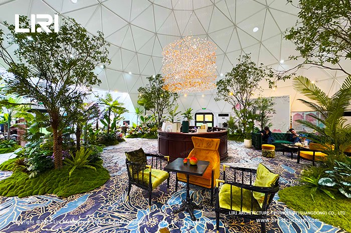 Pop-up lounge and reception area inside a landscaped geodesic dome tent