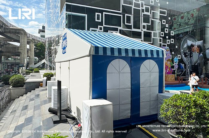 Side view of a compact modular pop-up shop in an urban retail plaza