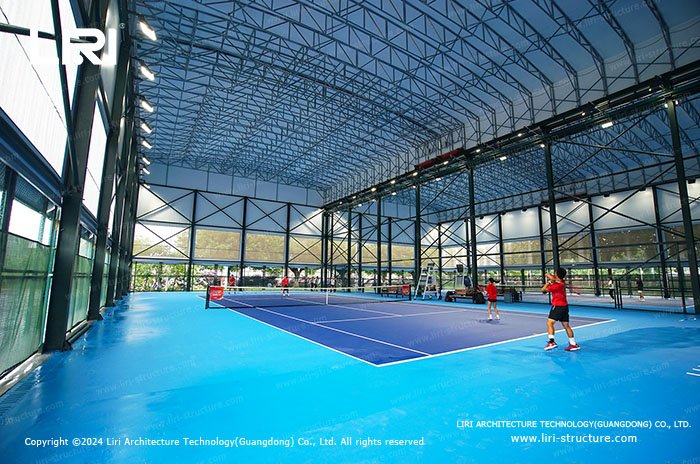 Sports tent interior for dual tennis court training with players on court