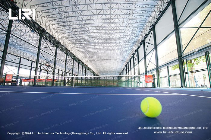 Tennis court tent interior with high roof clearance and side glazing
