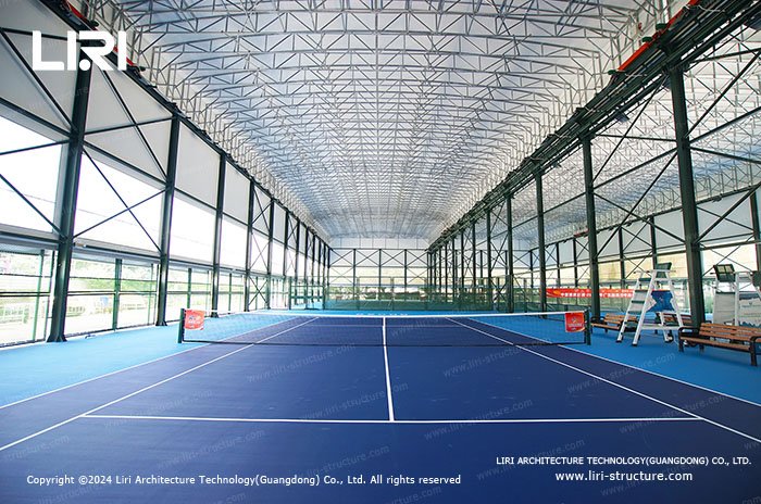 Two tennis courts inside a clear span sports tent structure